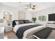 Bright main bedroom with ceiling fan, accent bench, and natural light at 10525 Lucaya Dr, Tampa, FL 33647