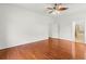 Bedroom featuring hardwood floors, ceiling fan, and an ensuite bathroom at 10525 Lucaya Dr, Tampa, FL 33647