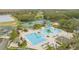 Aerial view of the resort-style community pool with lazy river, tennis courts, and beach volleyball at 10525 Lucaya Dr, Tampa, FL 33647