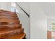 Hardwood staircase with black railings leading to the upper level of the home at 10525 Lucaya Dr, Tampa, FL 33647