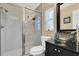 Bathroom with standing shower, glass sink, and tile flooring at 10907 Kewanee Dr, Temple Terrace, FL 33617