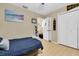 Cozy bedroom features wood floors, a full-sized bed, closet, and tastefully decorated in neutral colors at 10907 Kewanee Dr, Temple Terrace, FL 33617
