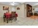 Cozy dining room area with tiled floors, classic wood furniture, and large hutch at 10907 Kewanee Dr, Temple Terrace, FL 33617