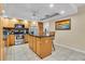 Spacious kitchen with stainless steel appliances and center island with stone countertop at 10907 Kewanee Dr, Temple Terrace, FL 33617