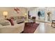 Bright living room with modern furniture, a large area rug, and stylish decor at 10907 Kewanee Dr, Temple Terrace, FL 33617