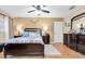 Comfortable main bedroom with ceiling fan, en suite, and wood-look flooring at 10907 Kewanee Dr, Temple Terrace, FL 33617