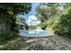 Backyard with pool, complemented by lush landscaping, providing a private outdoor oasis at 10907 Kewanee Dr, Temple Terrace, FL 33617