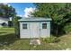 Outdoor shed features a gray exterior with blue trim and offers additional storage at 10907 Kewanee Dr, Temple Terrace, FL 33617
