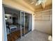 Enclosed sunroom with access to the living room featuring tile flooring, shelving and sliding glass doors at 11485 Oakhurst Rd # 319, Largo, FL 33774