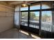 Enclosed sunroom featuring natural lighting, shelving, tile floor, and views of the surrounding greenery at 11485 Oakhurst Rd # 319, Largo, FL 33774