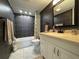 Modern bathroom featuring dark grey wall tile, marble floors, and a shower/tub combo at 11485 Oakhurst Rd # 319, Largo, FL 33774