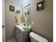 Compact half bath featuring a stylish vanity, framed mirror, and modern fixtures for convenience and functionality at 11485 Oakhurst Rd # 319, Largo, FL 33774