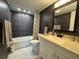 Bathroom featuring a shower-tub combination with modern tiles, vanity with light countertop, and sleek fixtures at 11485 Oakhurst Rd # 319, Largo, FL 33774
