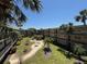 An exterior shot of the apartments and the building's courtyard, showcasing outdoor seating and lush landscaping at 11485 Oakhurst Rd # 319, Largo, FL 33774