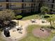 View of courtyard seating, barbecue, and landscaping, with seating tables with chairs at 11485 Oakhurst Rd # 319, Largo, FL 33774