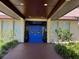 Front entrance to the recreation center with beautiful landscaping and double blue doors at 11485 Oakhurst Rd # 319, Largo, FL 33774