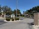 Community entrance sign surrounded by manicured landscaping and mature trees at 11485 Oakhurst Rd # 319, Largo, FL 33774