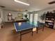 The game room features a pool table, ping pong table, and shelving with games and books for community residents to enjoy at 11485 Oakhurst Rd # 319, Largo, FL 33774