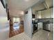 Kitchen with stainless steel appliances and gray granite countertops connecting to the living room at 11485 Oakhurst Rd # 319, Largo, FL 33774
