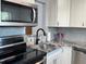 Updated kitchen features stainless steel appliances and gray granite countertops at 11485 Oakhurst Rd # 319, Largo, FL 33774
