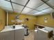 Clean laundry room with multiple machines at 11485 Oakhurst Rd # 319, Largo, FL 33774