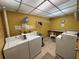 Clean laundry room with multiple machines at 11485 Oakhurst Rd # 319, Largo, FL 33774