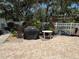 Landscaped outdoor grill area featuring a grill, table, and paved patio for entertaining and enjoying outdoor meals at 11485 Oakhurst Rd # 319, Largo, FL 33774