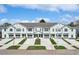Charming multi-Gathering home featuring a row of townhouses with individual garages and landscaped front yards at 11718 Blackbrook Ct, Seffner, FL 33584