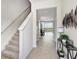 Bright foyer with staircase, tile flooring, and stylish decor welcomes you into this spacious home at 11718 Blackbrook Ct, Seffner, FL 33584
