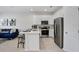 Modern kitchen with stainless steel appliances, white cabinetry, and a center island with bar stool seating at 11718 Blackbrook Ct, Seffner, FL 33584
