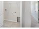 Bright laundry room featuring tile floor, utility sink, and storage shelves at 11718 Blackbrook Ct, Seffner, FL 33584