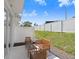 Private patio with a seating area and a view of the well-maintained, fenced backyard at 11718 Blackbrook Ct, Seffner, FL 33584