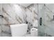 Bathroom showcasing a modern tub, shower and large tile with contemporary fixtures at 1204 Croydonwood Cir, Brandon, FL 33510