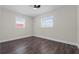 Cozy bedroom has bright windows, hardwood floors, and neutral paint at 1204 Croydonwood Cir, Brandon, FL 33510