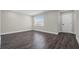 Bright bedroom featuring dark wood floors, neutral walls, and natural light at 1204 Croydonwood Cir, Brandon, FL 33510