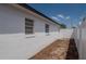 View of the side of the home with a well-maintained exterior and white fence at 1204 Croydonwood Cir, Brandon, FL 33510