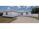 Exterior view of the single-story home showcasing its painted concrete and garage at 1204 Croydonwood Cir, Brandon, FL 33510