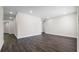 Open-concept living room with dark wood floors, white trim and neutral walls at 1204 Croydonwood Cir, Brandon, FL 33510