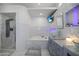 Modern bathroom features a glass bowl sink, soaker tub, walk-in shower, and television at 13528 Woodside Dr, Hudson, FL 34667