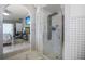 Modern bathroom featuring a rainfall shower, sleek glass doors, and a soothing color palette at 13528 Woodside Dr, Hudson, FL 34667