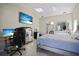 Stylish bedroom with sleek furnishings, including desk, mini fridge, and TV, offering a relaxing and functional space at 13528 Woodside Dr, Hudson, FL 34667