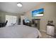 Bright bedroom featuring a workspace with computer, TV, and large windows, offering both comfort and functionality at 13528 Woodside Dr, Hudson, FL 34667