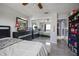 Spacious bedroom with mirrored closet doors, tile floor, ceiling fan, and neutral walls at 13528 Woodside Dr, Hudson, FL 34667