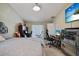 Bright bedroom featuring neutral walls, tiled floors, and modern furnishings at 13528 Woodside Dr, Hudson, FL 34667