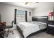 Comfortable bedroom with window, ceiling fan, and a black dresser with drawers at 13528 Woodside Dr, Hudson, FL 34667