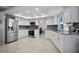 Bright kitchen features recessed lighting, stainless appliances, and white cabinets at 13528 Woodside Dr, Hudson, FL 34667