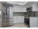 Kitchen has stainless steel appliances and white cabinets, granite countertops and tile backsplash at 13528 Woodside Dr, Hudson, FL 34667