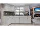 Spacious kitchen features stainless appliances and a view of outdoor pool area at 13528 Woodside Dr, Hudson, FL 34667