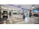 Modern kitchen featuring stainless steel appliances, white cabinetry, and an eat-in island at 13528 Woodside Dr, Hudson, FL 34667