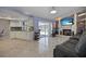 Open living room and kitchen area with fireplace and sliding glass doors to the pool at 13528 Woodside Dr, Hudson, FL 34667